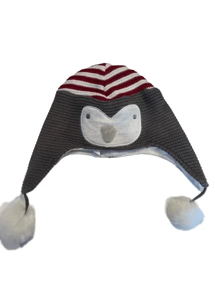 penguin baby hat with red stripes on the top and pom poms hanging down
